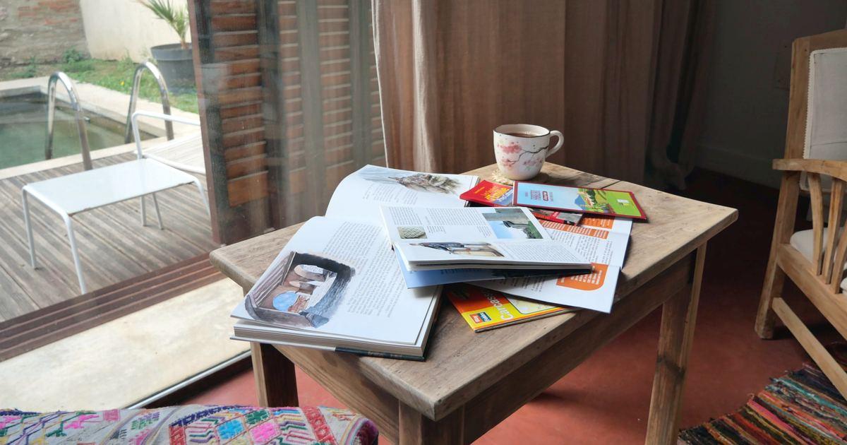 Authentic documents on a table in the living room by the pool: books, local brochures and a map of Carcassonne